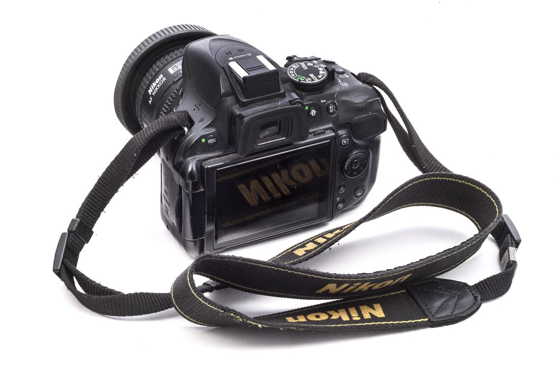 Camera (Nikon Model D5200) with 24 mm. lens (AF Niccor) and strap, used by Bill Cunningham, ca. 2012. (Glenn Castellano, New-York Historical Society)